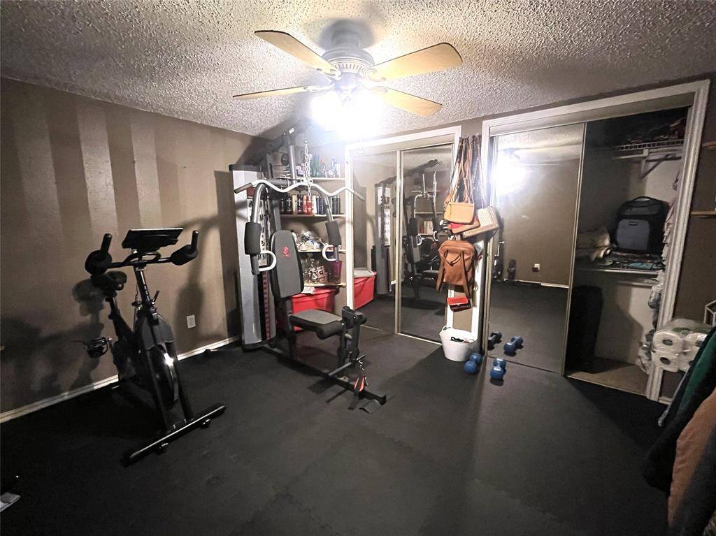Bedroom with double closets currently used as an exercise room
