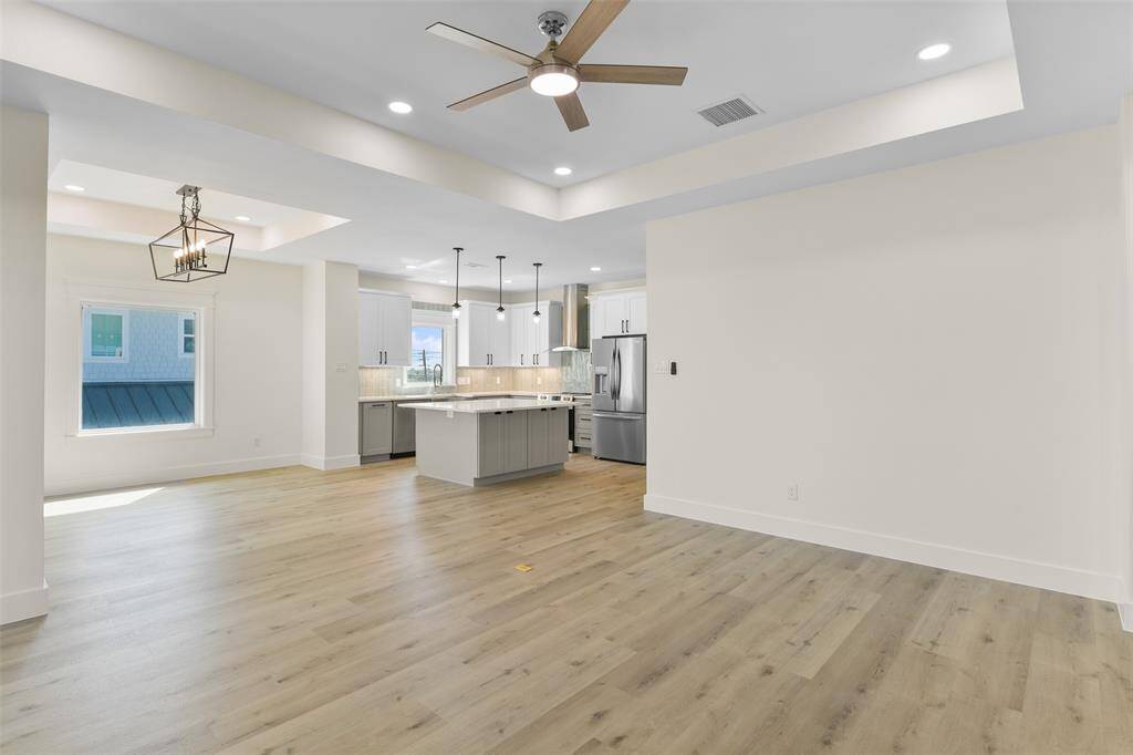 Enjoy seamless entertaining in this open-concept living room that flows effortlessly into the modern kitchen, ensuring you're always part of the action.