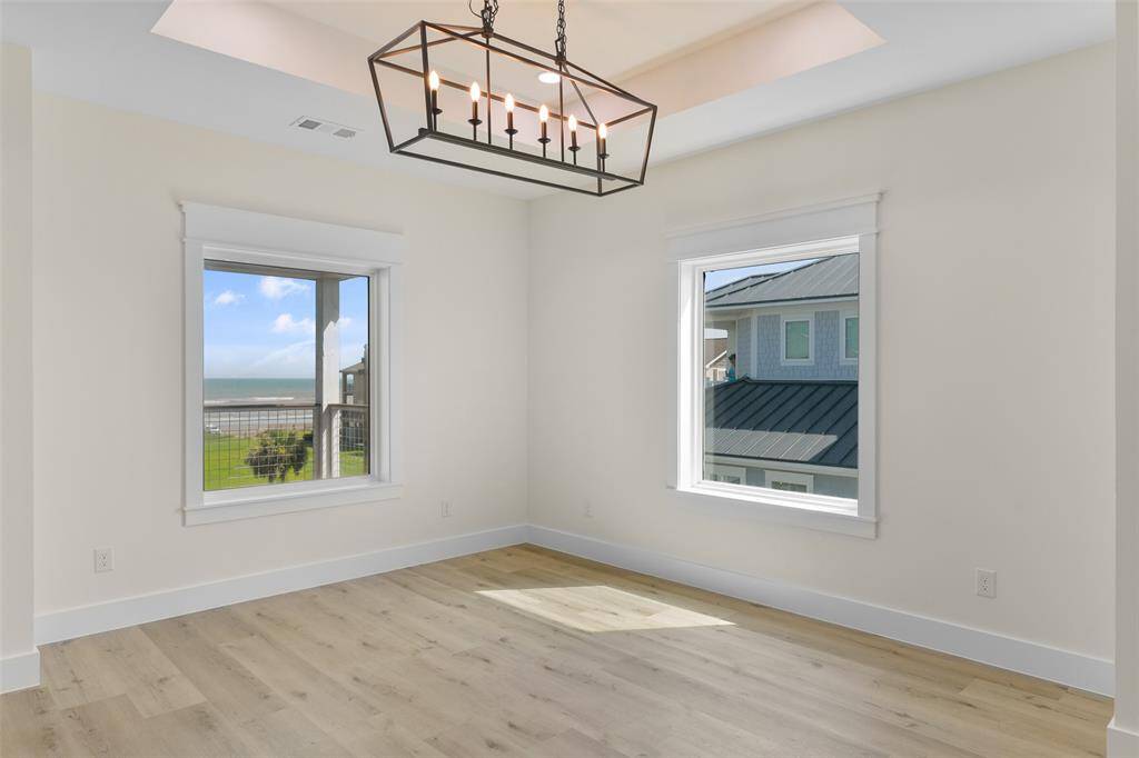 Enjoy panoramic views in this light-filled dining area, framed by expansive windows.