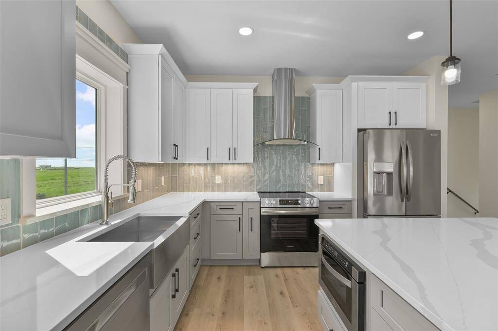 Maximize your culinary experience in this kitchen, which that features generous storage, sleek stainless steel appliances, and a built-in microwave.