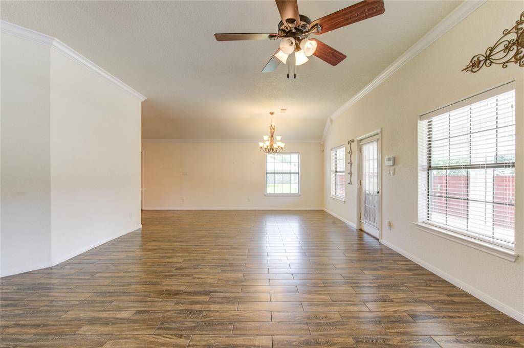 Combined living and dining area with direct access to the outdoors via a door with glass panes.