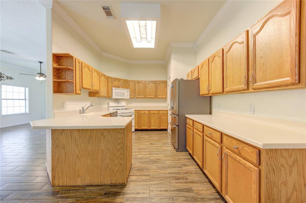 Kitchen with ample  cabinetry and modern appliances.