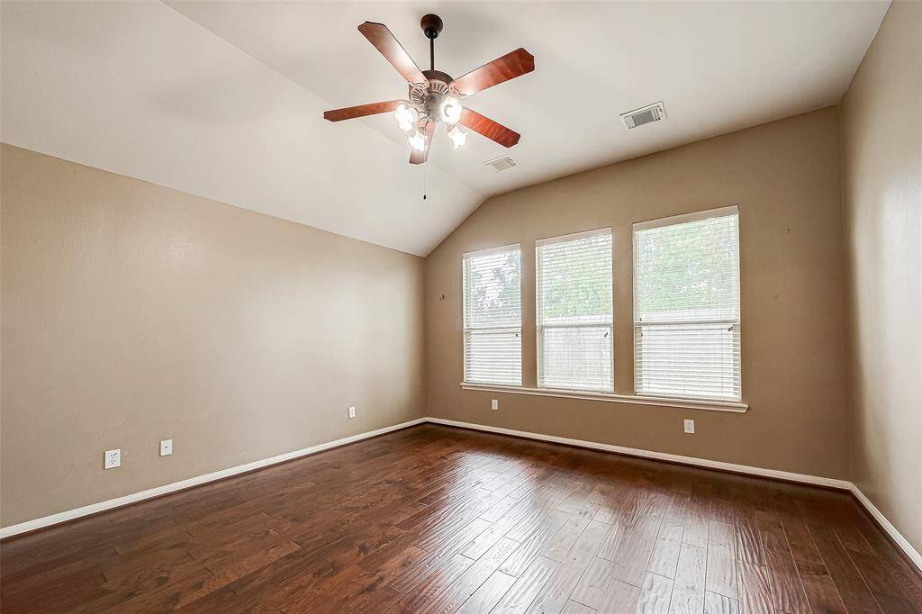 The family room leads to Primary Suite, with vaulted ceiling.