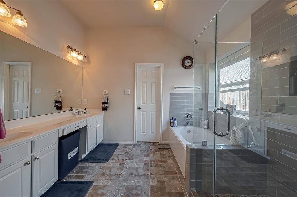 Relax and unwind in your en suite bath. Wash all your worries away in the large soaking tub.  Walk-in shower with glass enclosure.