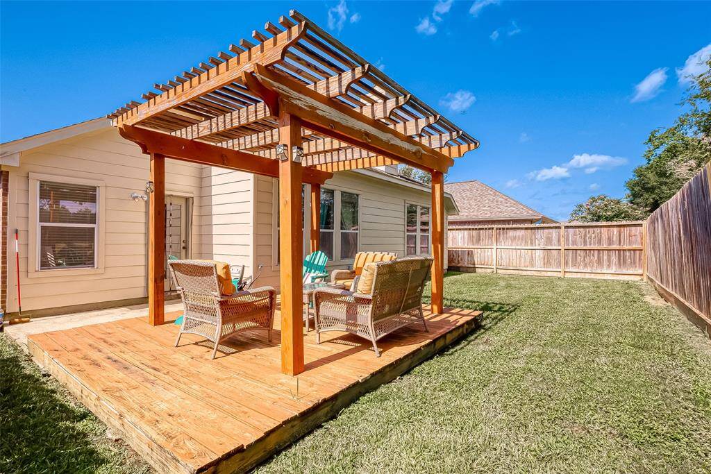 Enjoy the backyard space under the pergola.