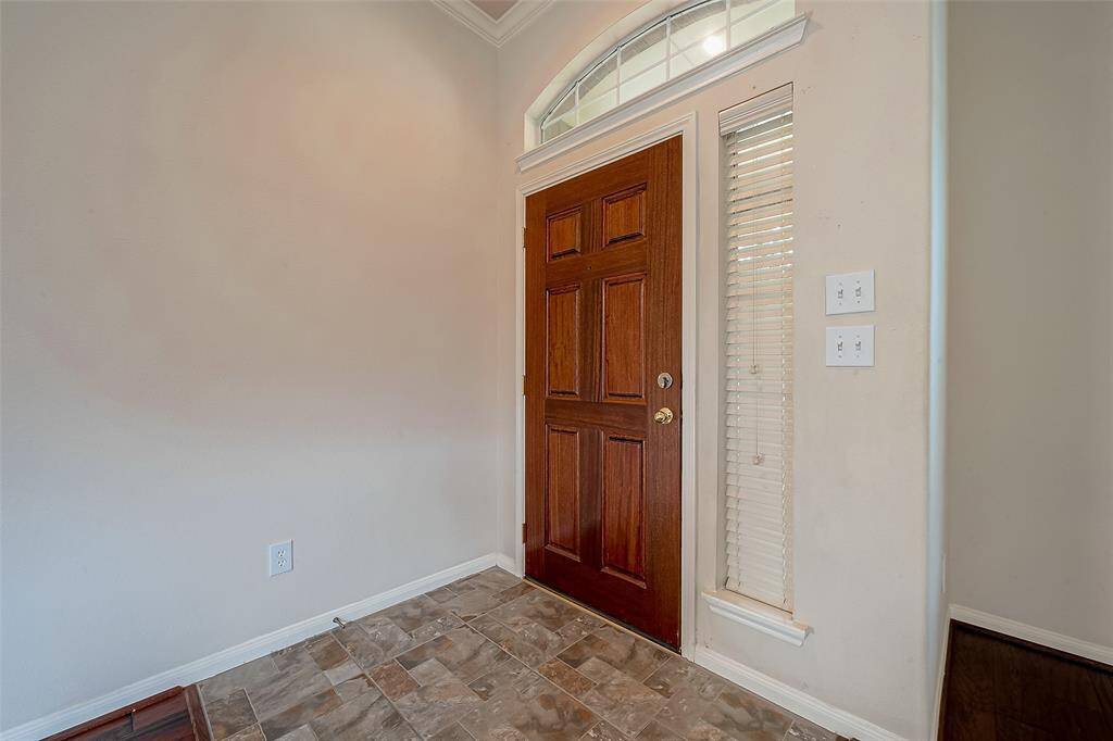 View of entrance inside home from formal living or dining area.