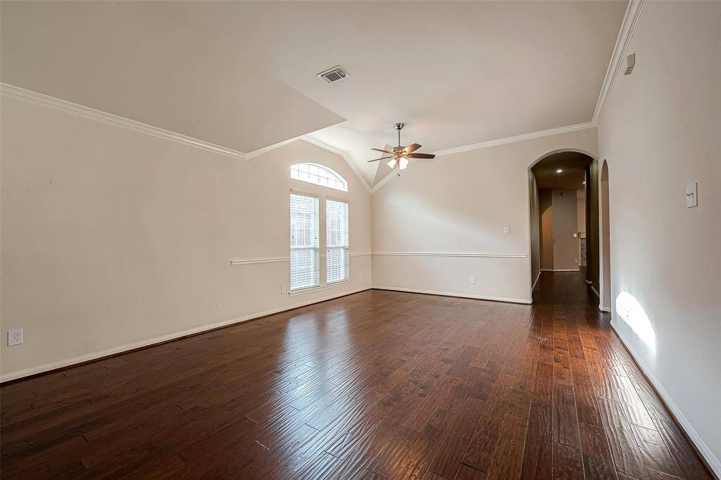 View from entrance into the inviting space with lots of natural light and real wood floors.