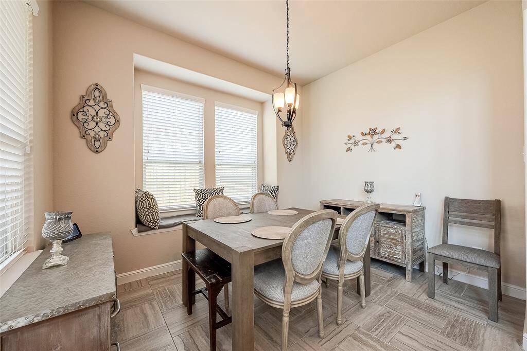 Dining area features  a window seat and space for buffet.