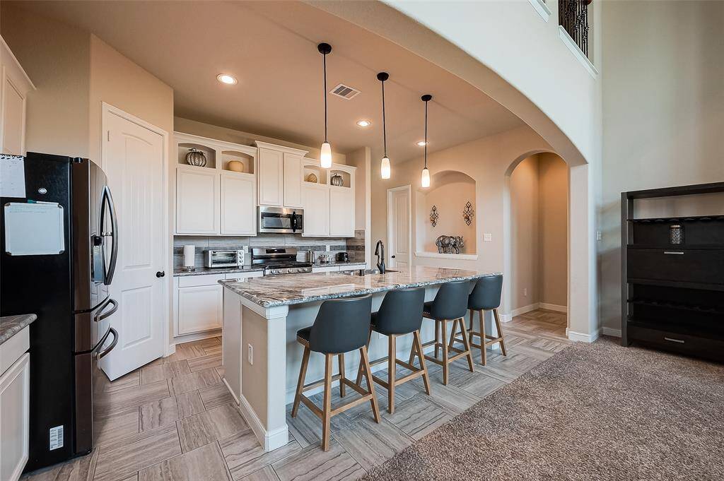 Island kitchen overlooks living space.