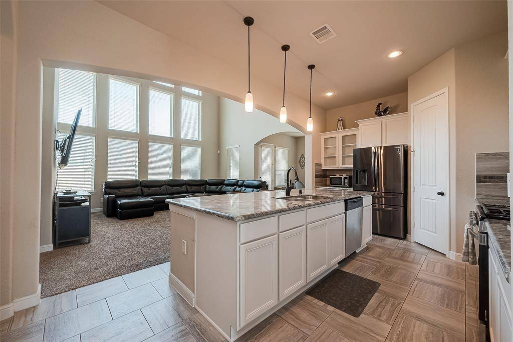 Island kitchen provides additional prep space, storage and breakfast bar.