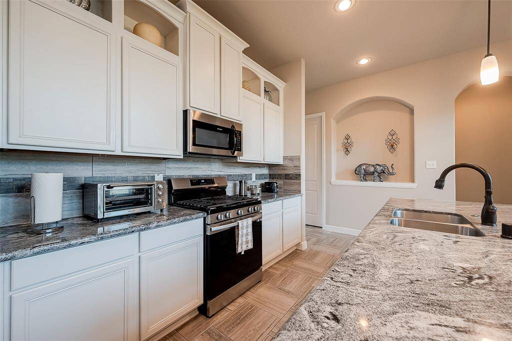 Unique granite counters and additional storage space over cabinets.
