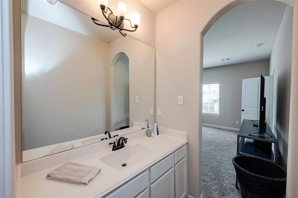 Upstairs full bath has two separate vanities.
