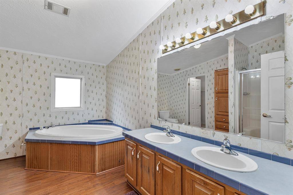 Double sinks with soaking tub in primary bathroom