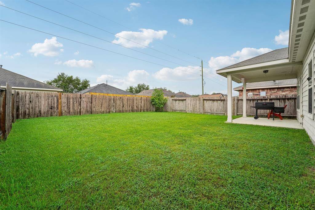 Large backyard with covered patio