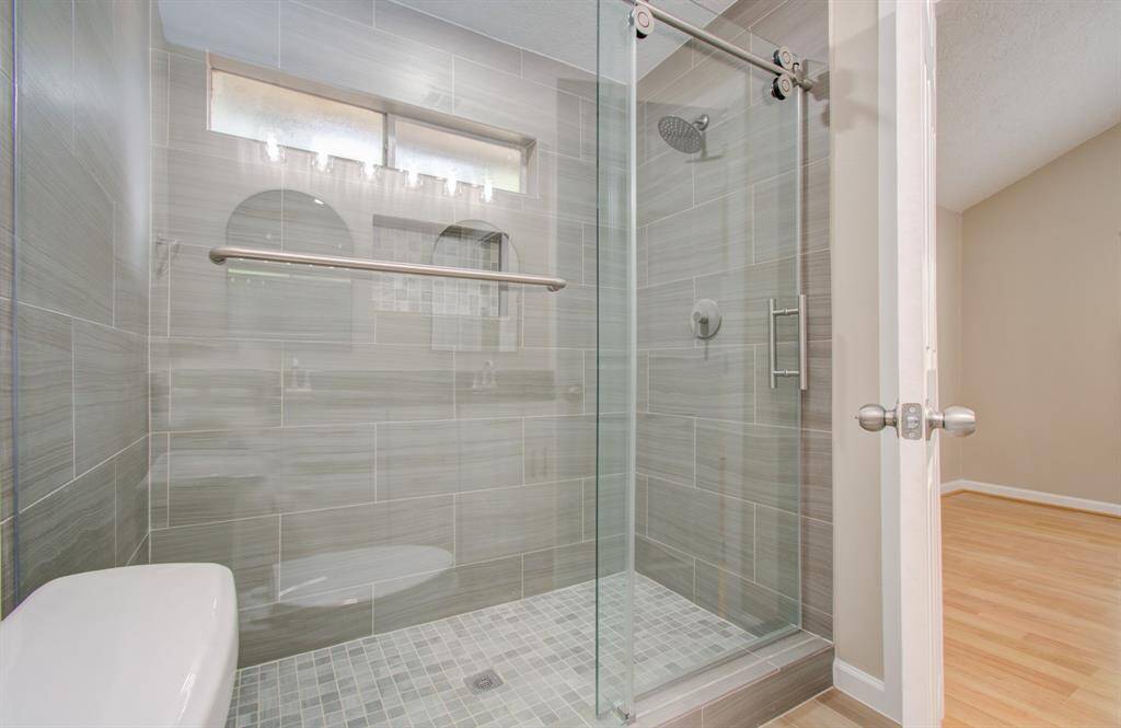 Elegant walk-in shower with custom tilework.