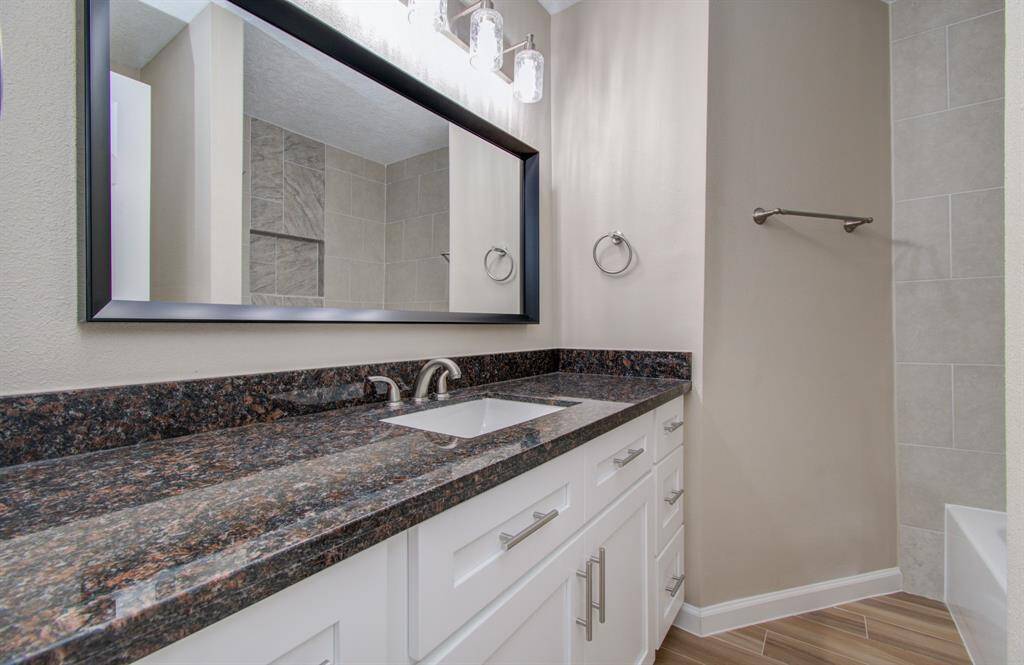 Elegant granite countertops enhance both bathrooms.