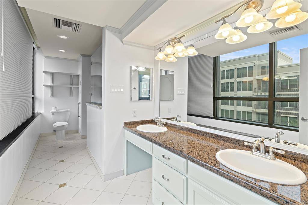 Primary bath with large walk-in shower, walk-in whirlpool tub, double sinks and heated floors.