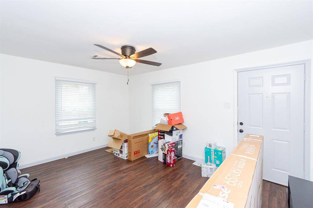Large living room with large windows and LVP floors