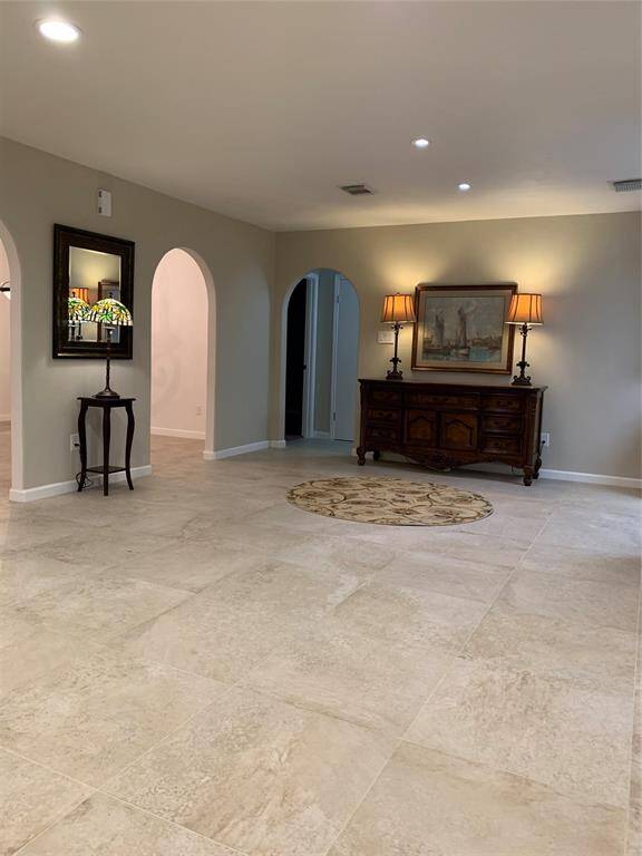 This view is looking into the breakfast area. The kitchen is located to the right and the formal dining room is on the left. The doorway next to the sideboard leads to the secondary bedrooms.