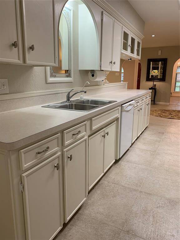 Plenty of counter space and cabinetry in this immaculate galley kitchen.