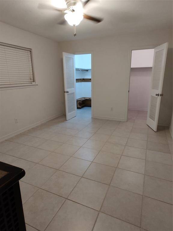 This is the second guest bedroom located in the back of the home. It features two walk-in closets!
