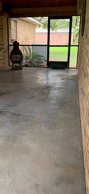 Covered and screened patio located between the home and detached garage.