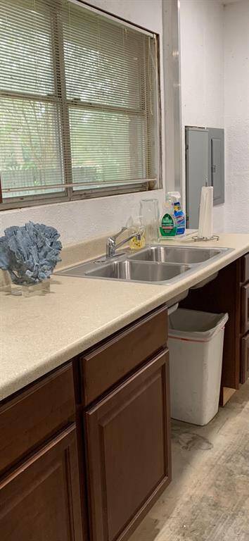 Convenient sink and counter/cabinets are located in the oversized garage.