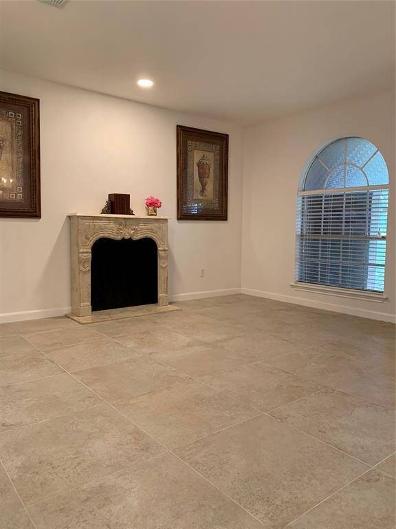 This is the formal living room with a mock fireplace (will not stay).