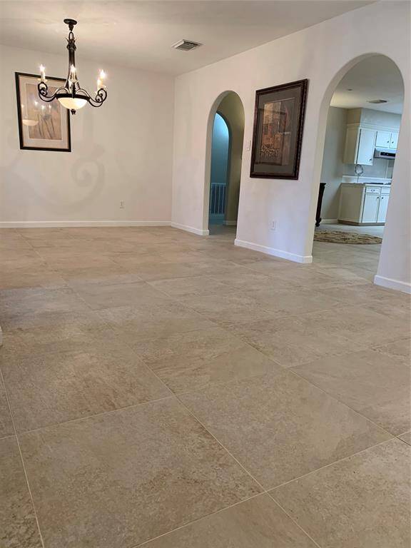 As you walk in the front door, the formal dining room is on the left with an arched doorway opening to the breakfast area, kitchen and family room.