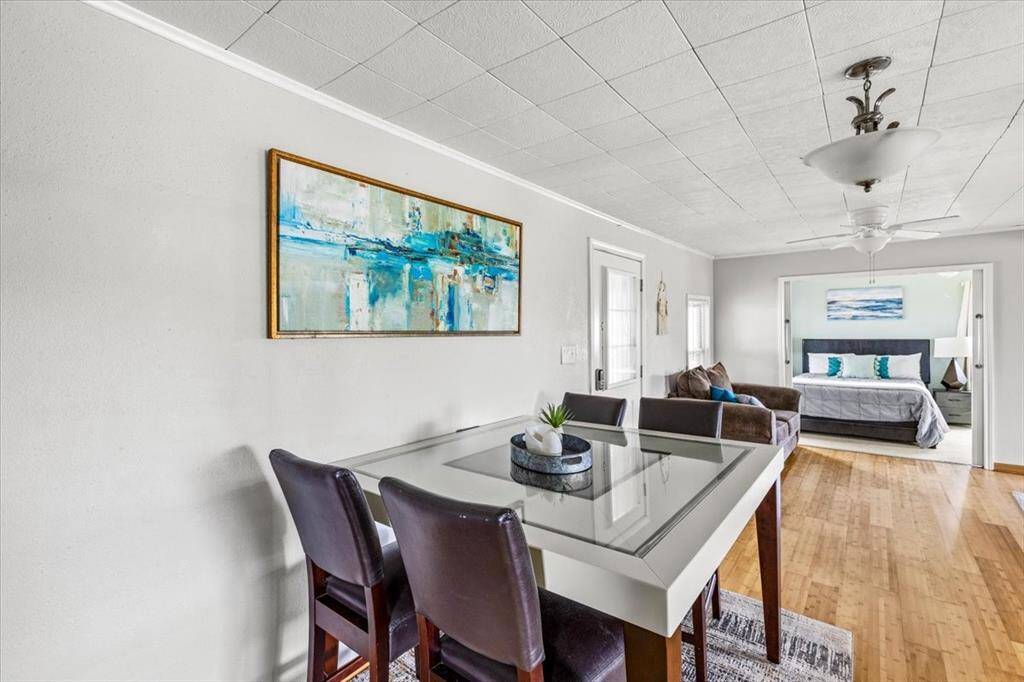dining room, open to kitchen and living room. Primary bedroom access through large sliding doors.