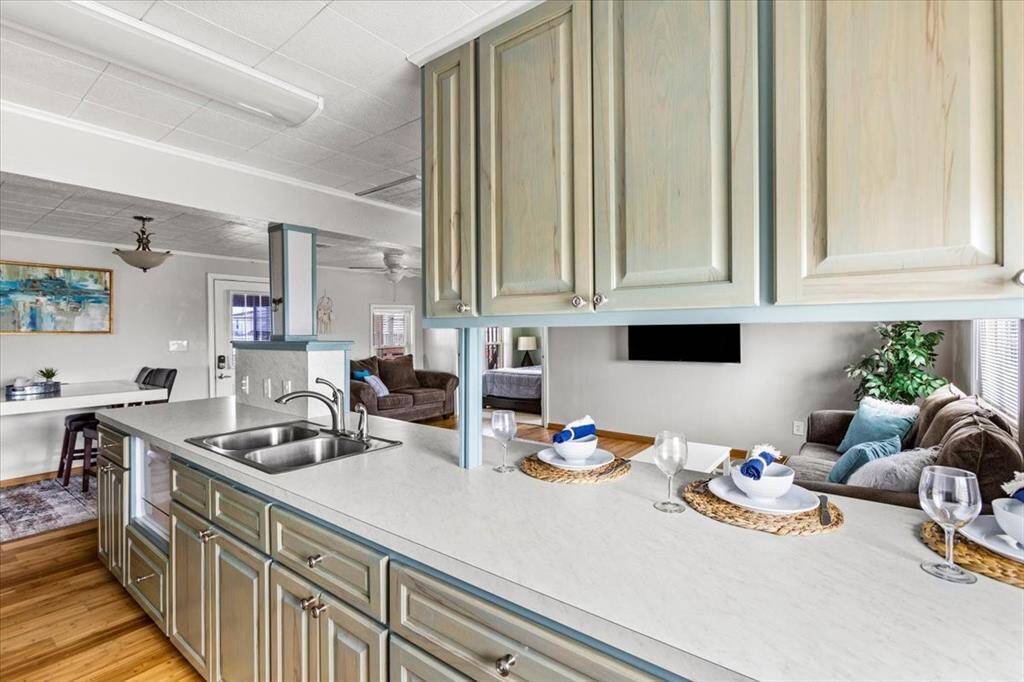 Large kitchen with lots of hardwood custom cabinets and counter space. Eat-in bar.