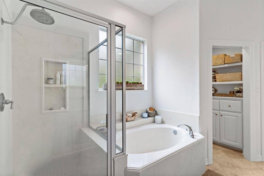 Stand up shower and soaker tub in primary bathroom.