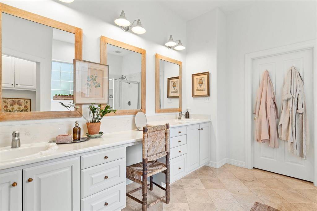 Primary bath with double sinks and vanity area.