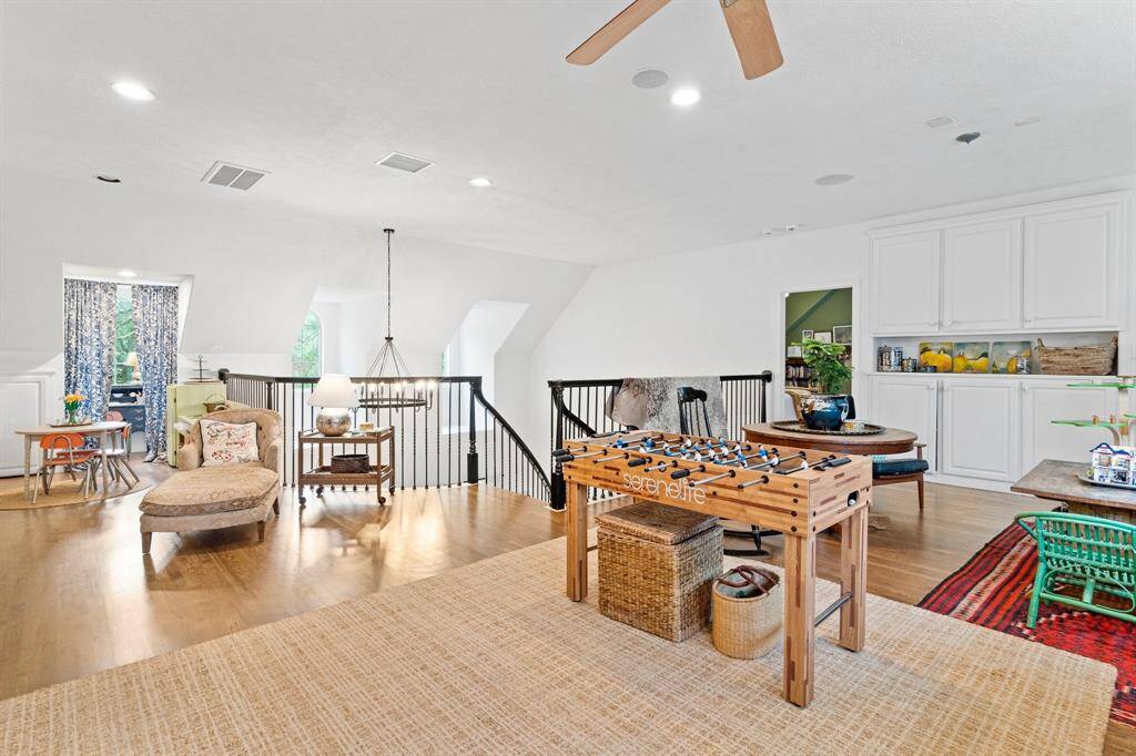 Gameroom upstairs with wood floors.