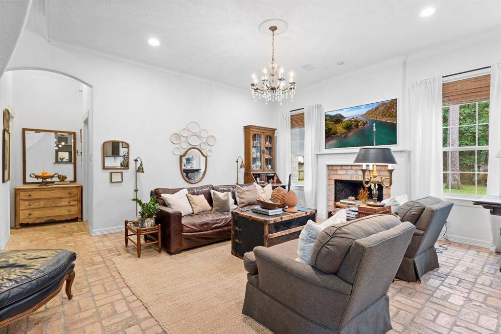 Open family area with gas fireplace and high ceilings.