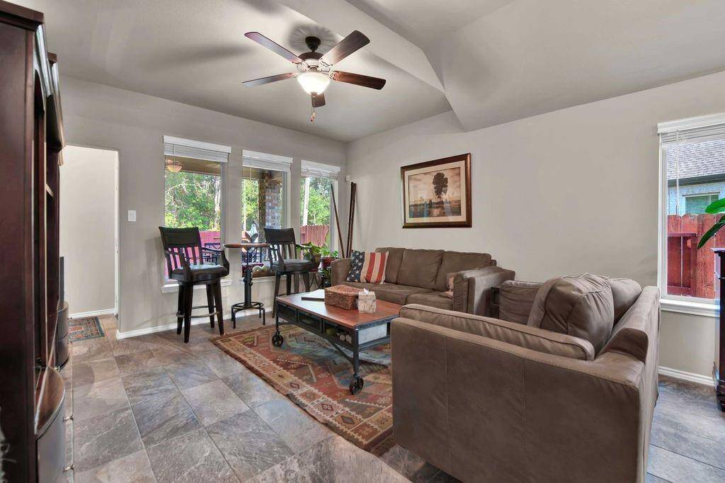 Family room with 3 bright windows looking onto the back patio