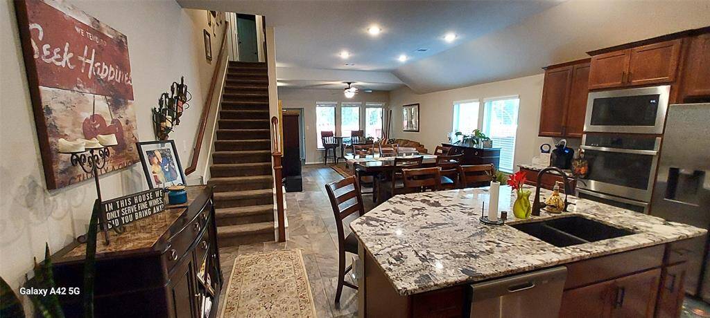 Kitchen flows into dining area and family room