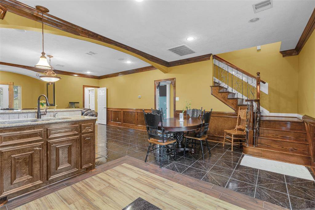 Elegant Dining Retreat: Seamlessly connected to a sophisticated kitchen, this cozy dining space is accented with rich wood finishes and tasteful lighting—ideal for delightful dining experiences and social gatherings.