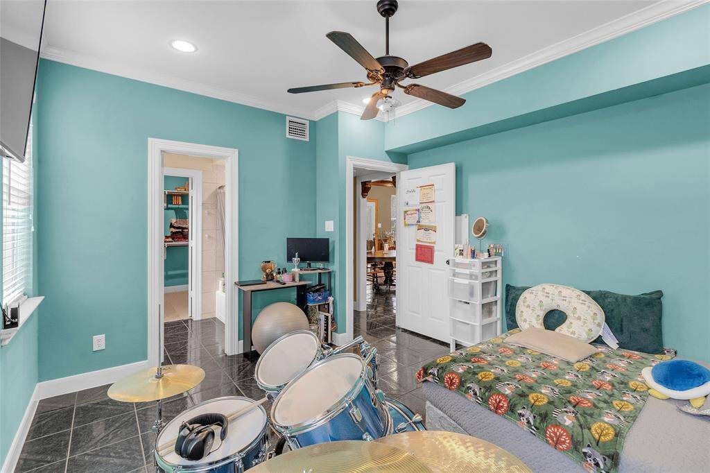 Spacious ground-level bedroom blending modern amenities with inviting aesthetics.