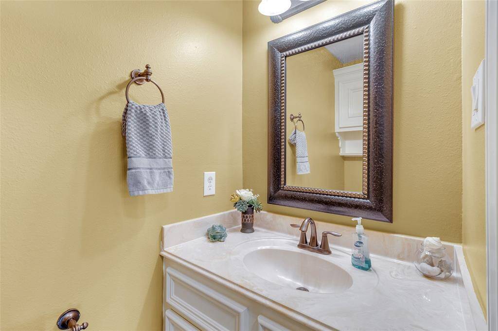 Charming ground floor powder room with elegant fixtures and warm, inviting tones.
