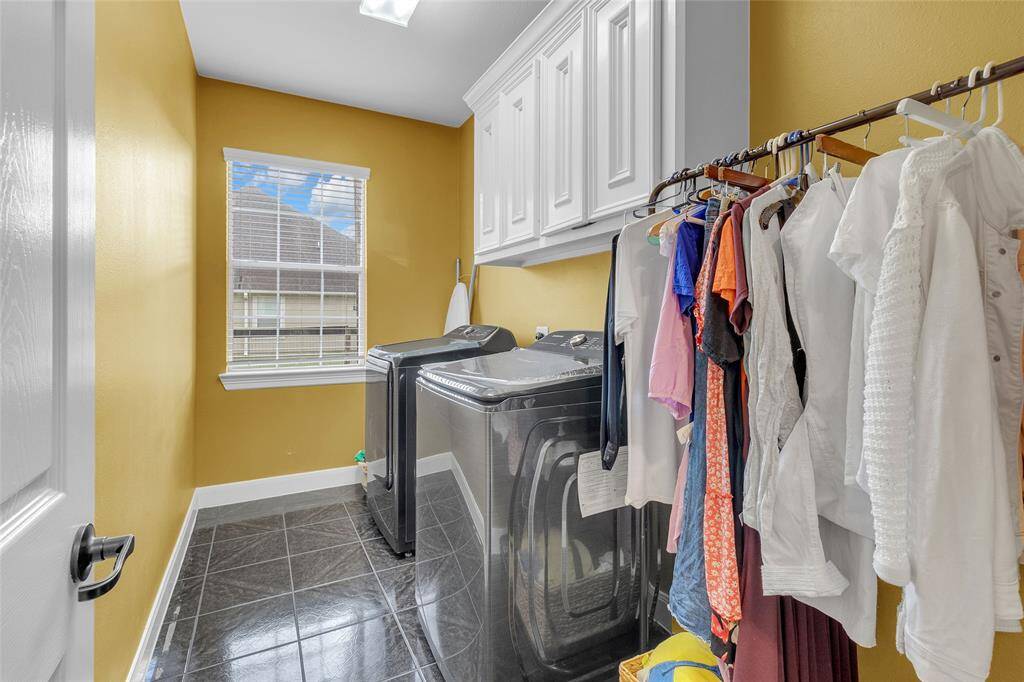 Efficient laundry space with modern appliances, ample storage, and natural light.