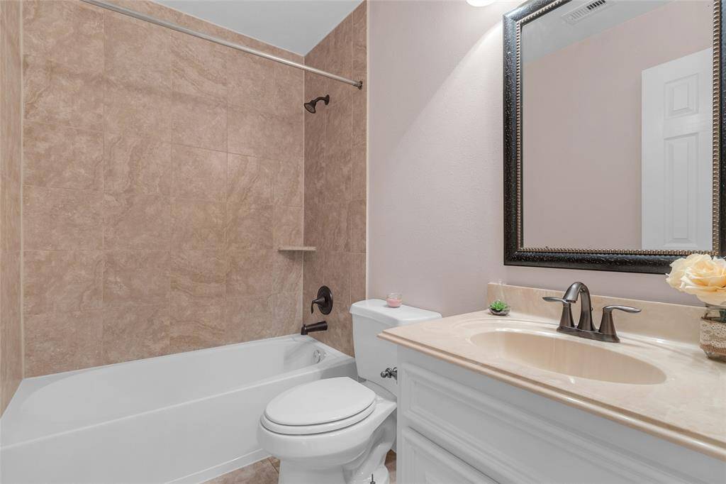Elegant full bath featuring a soothing neutral palette, modern fixtures, and a spacious shower-tub combo for a serene personal oasis.