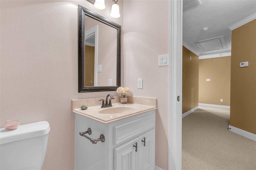 Discover tranquility in this chic, spa-like bathroom with a stylish shower-tub combination, contemporary fixtures, and a calming color scheme to create your perfect retreat.