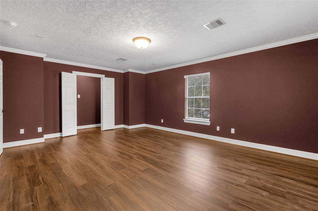 Versatile Room: A spacious, multi-functional area with elegant hardwood flooring, perfect for a home office, gym, or entertainment center.