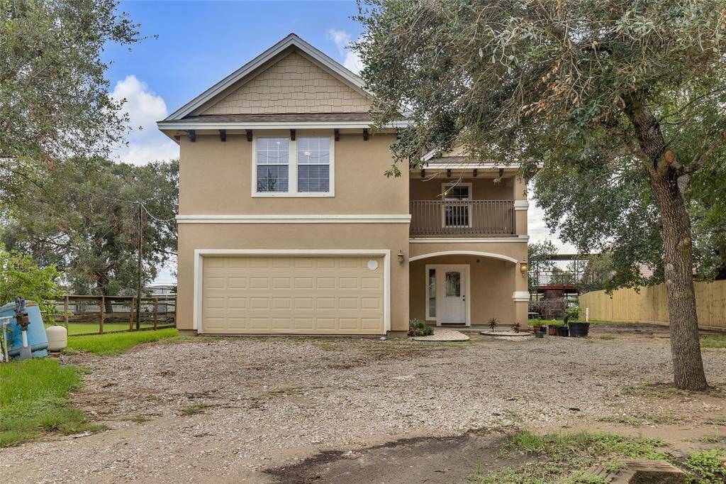 Charming Two-Story Home with full grown trees and see the water well to the left? You have both well water and public water!