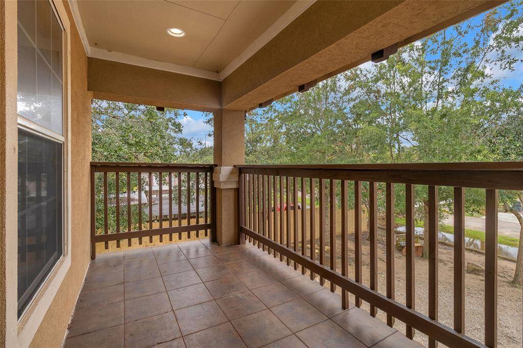 Charming, covered balcony with tranquil views, perfect for relaxation and outdoor dining.