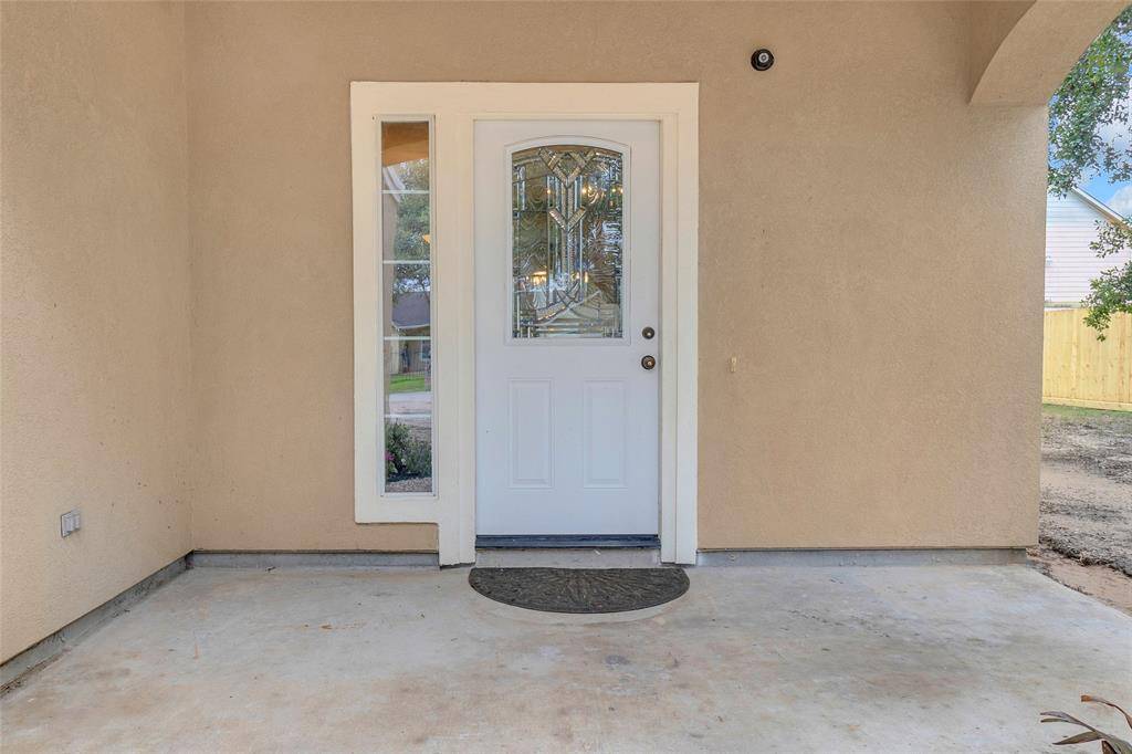 Elegant Entryway with decorative glass detailing, nestled within a cozy, covered porch area.