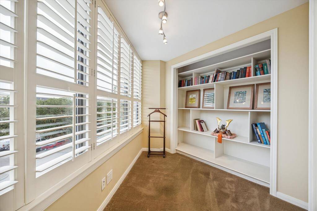 Adjacent to the primary bedroom is a versatile flex space, ideal as a home office, closet, nursery, or hobby room. Enjoy the flexibility and partial view.