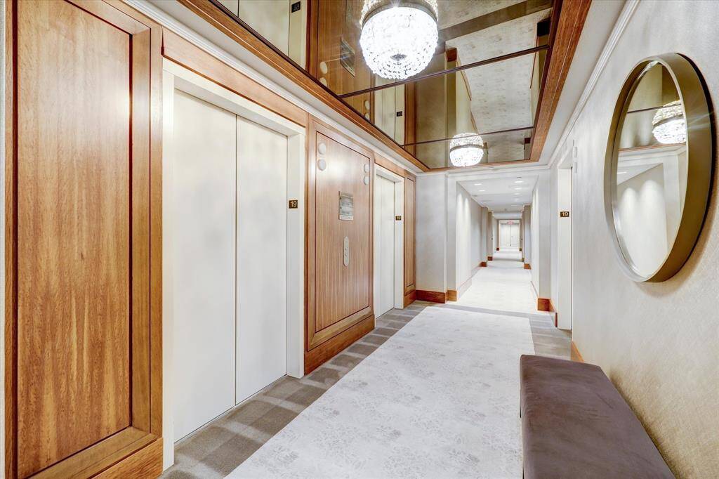 Elegant hallway featuring sleek elevator access and stylish lighting.