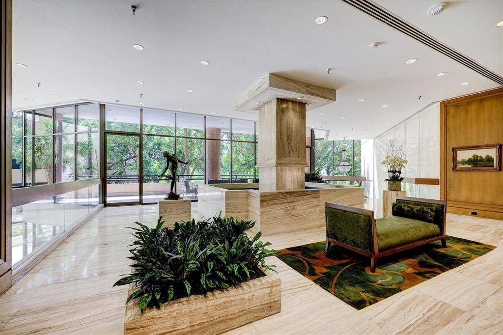 Elegant lobby with an outdoor terrace offering stunning views of the gardens, pool, and grounds.